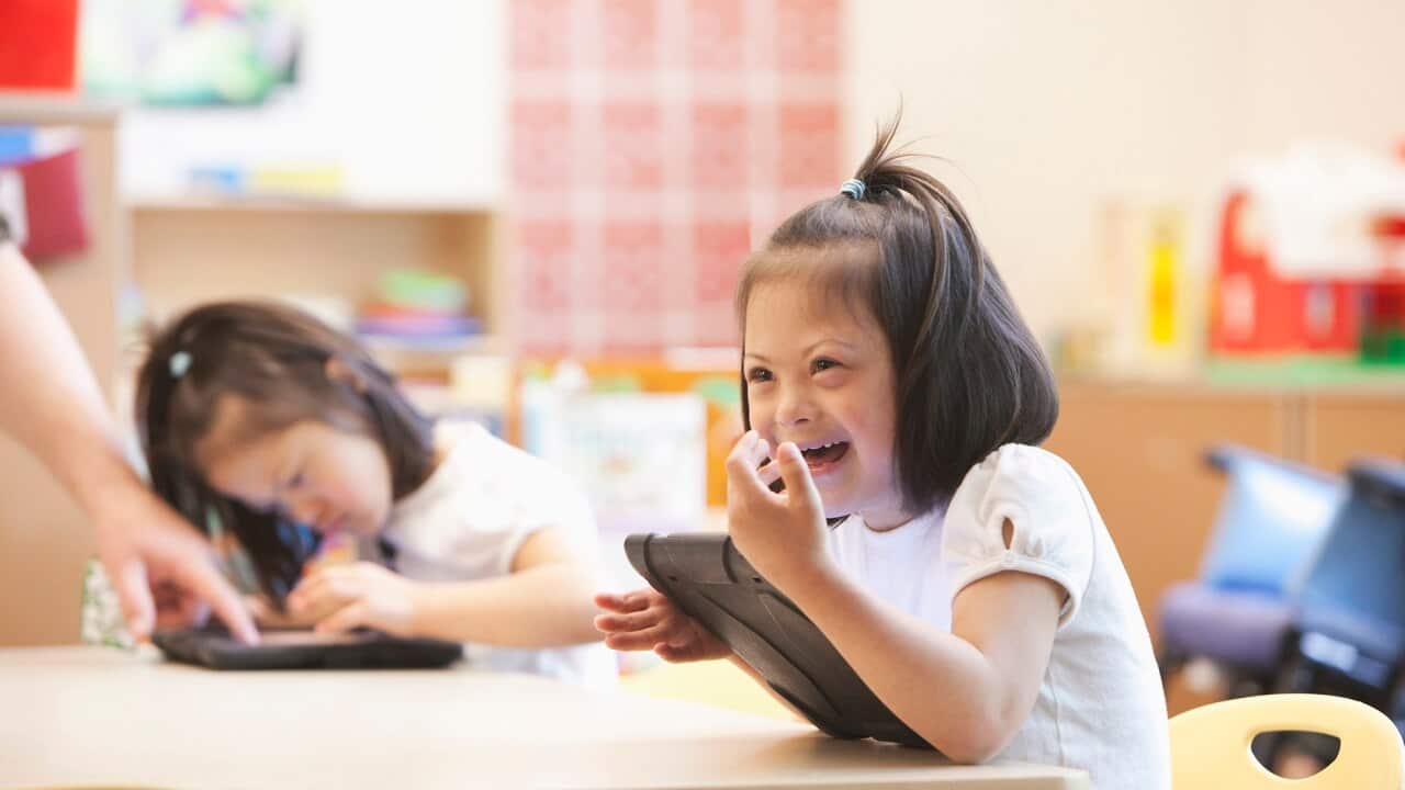 Young Down syndrome student in classroom.