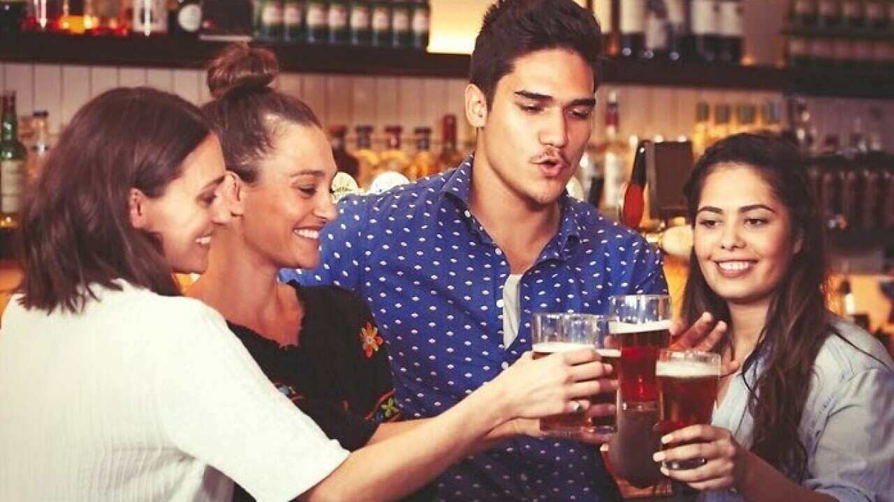 Young people enjoying a drink at a pub