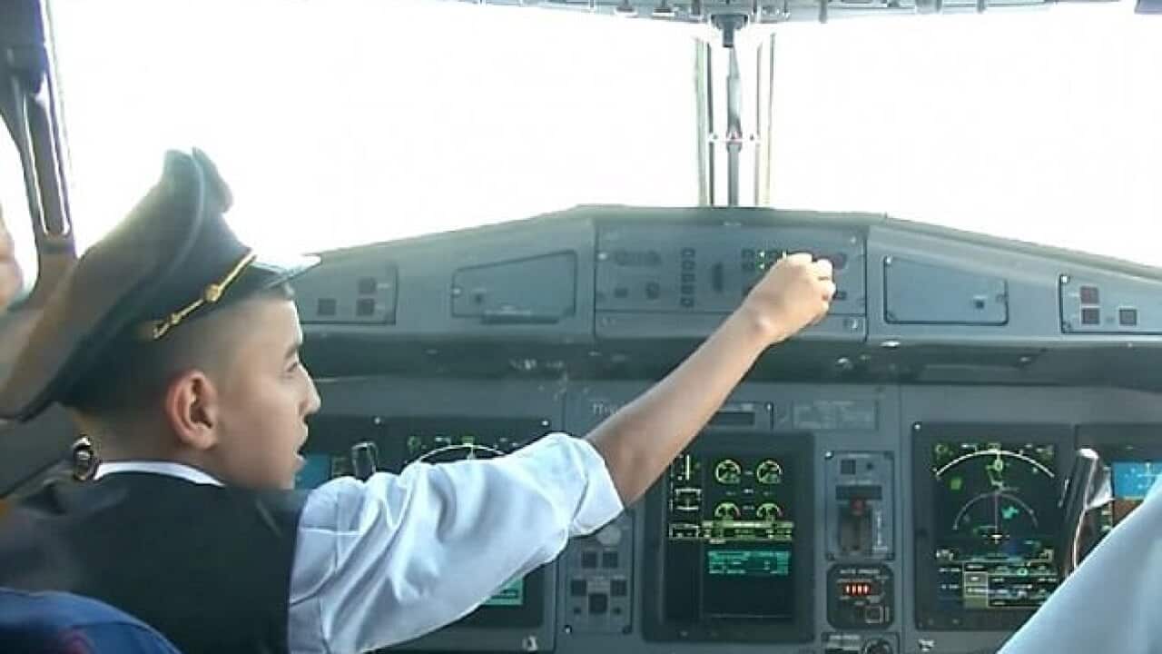 Two pilots for Algeria's national carrier have been suspended after handing over control of a plane to an orphaned boy as part of a TV stunt