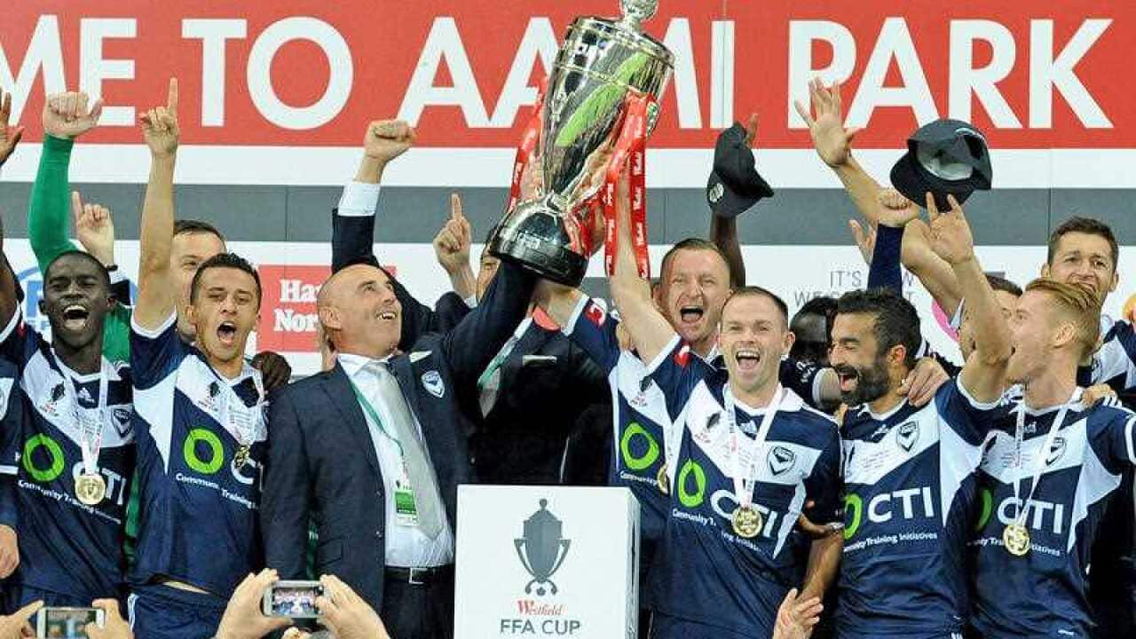 Melbourne Victory team celebrates after winning the FFA final match.