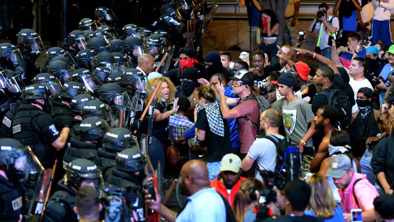 Charlotte-Mecklenburg police officers begin to move protesters