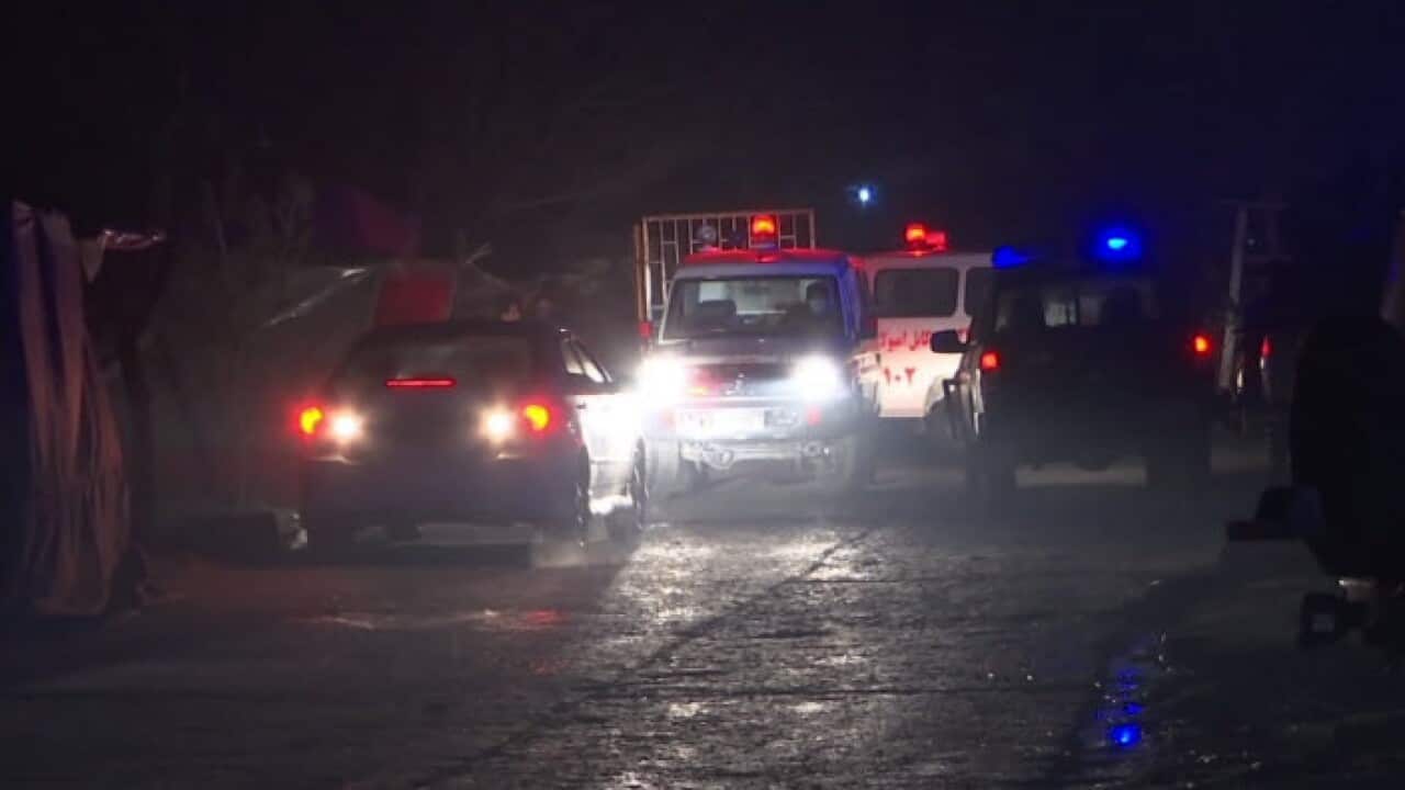ambulances and security forces near the scene of an explosion in Kabul