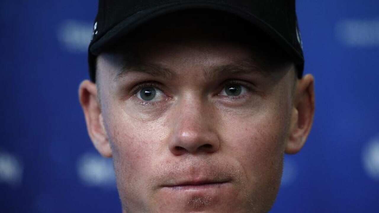 Sky Team rider Chris Froome looks on.
