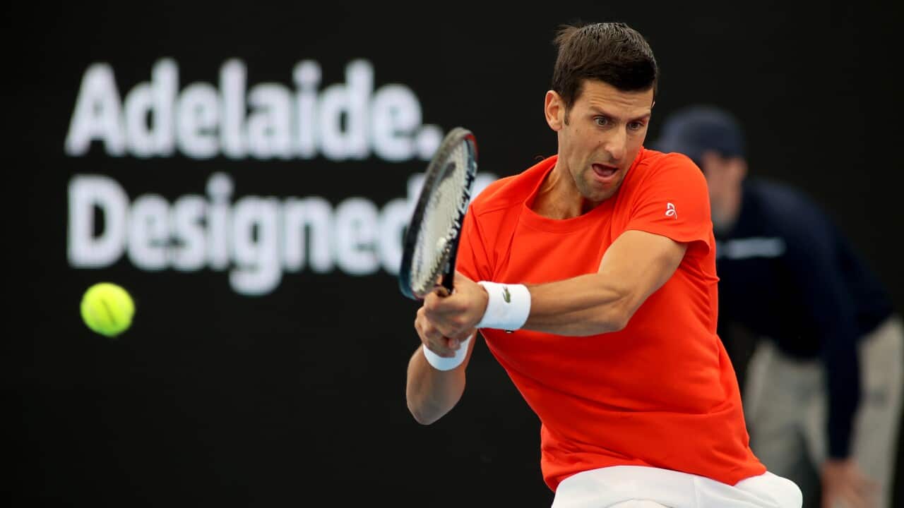 Novak Djokovic of Serbia plays a backhand against Jannik Sinner of Italy during a tennis event at Memorial Drive Tennis Centre in Adelaide