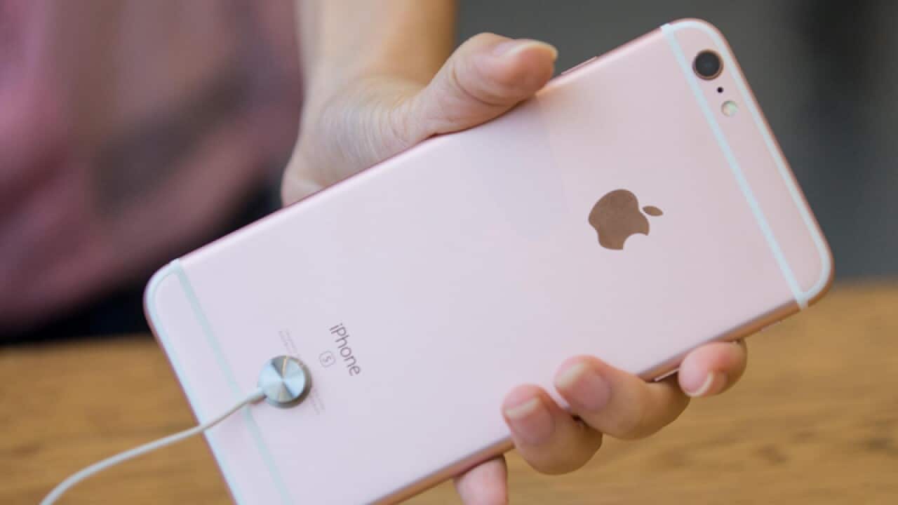A customer tries out an iPhone at an Apple Store
