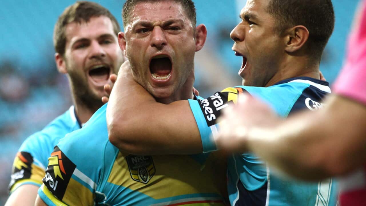 Mark Minichiello celebrates scoring a try