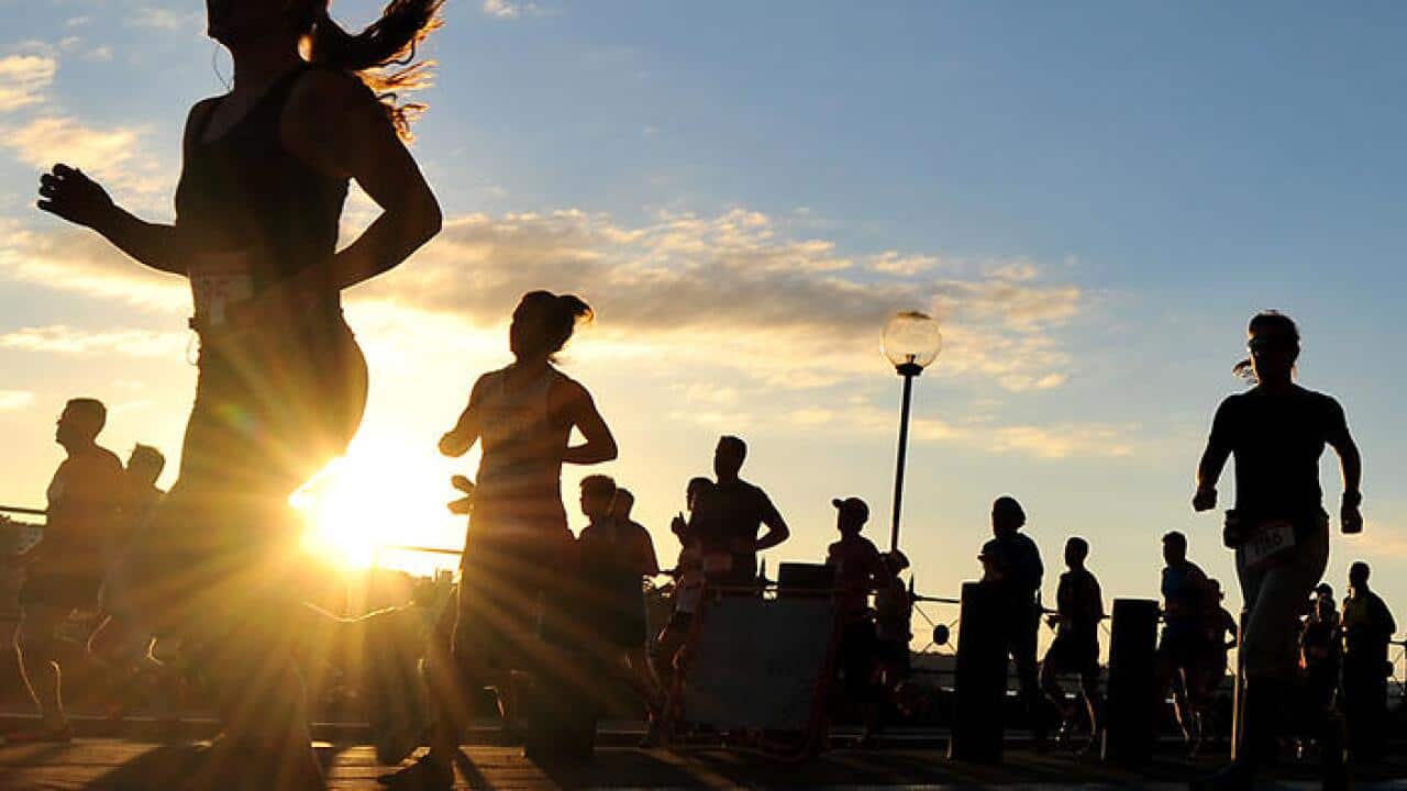 Competitors pass beneath the Harbour Bridge as they take part in the half marathon running race in Sydney on Sunday, May 19, 2013. (AAP Image/Paul Miller) NO ARCHIVING