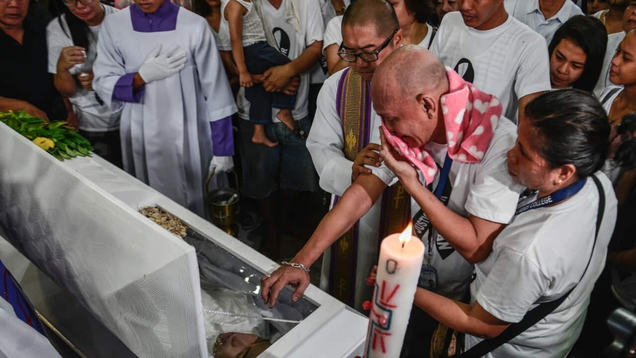 The parents and relatives of Kian Loyd Delos Santos weep over his coffin during his funeral rites in Caloocan, Metro Manila, Philippines, August 26.