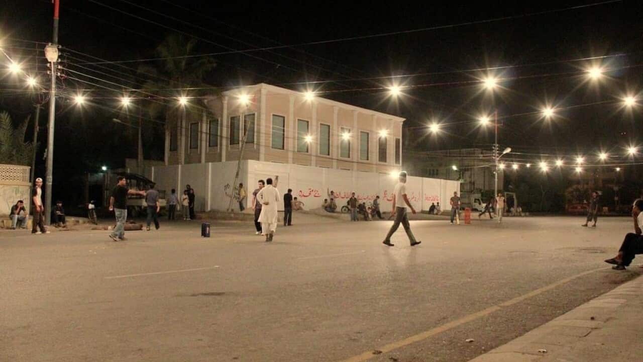 Scene is set for a night cricket match on suburban street of Karachi.