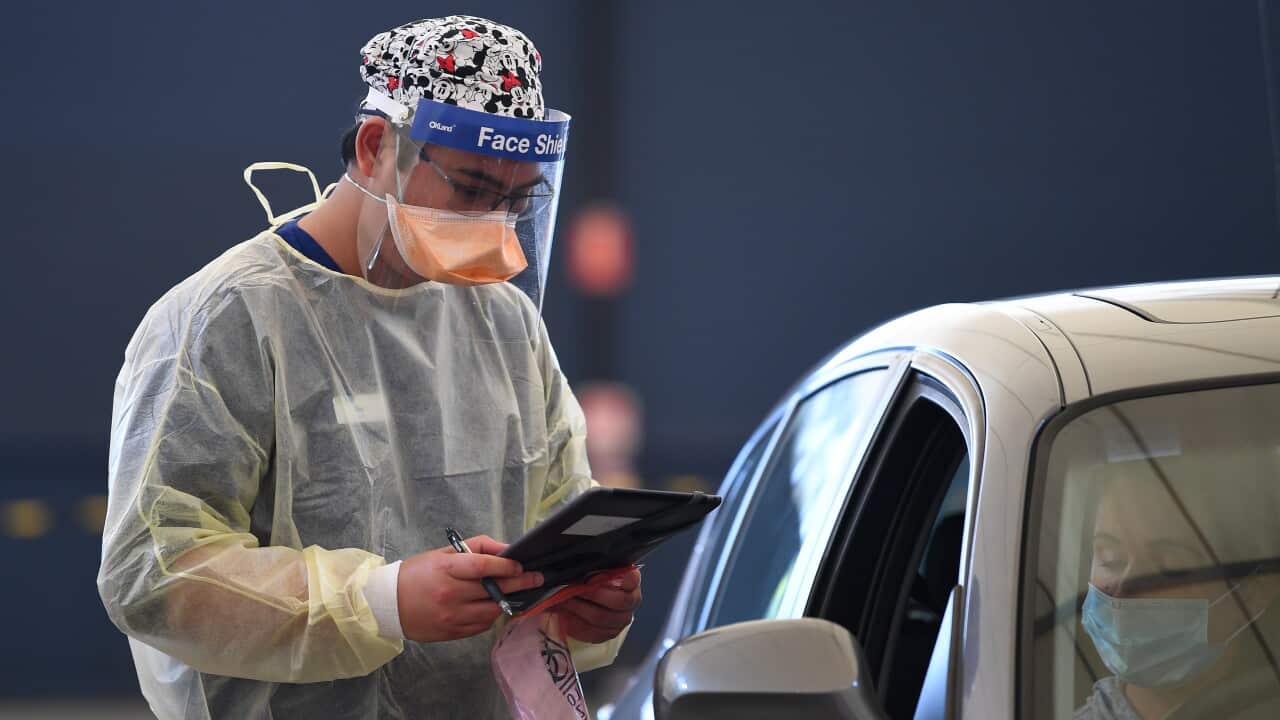 A health care worker at a drive-through COVID-19 testing facility in Melbourne.