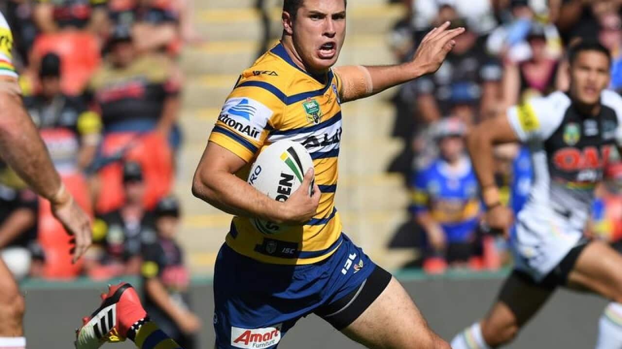 Mitchell Moses carries the ball.