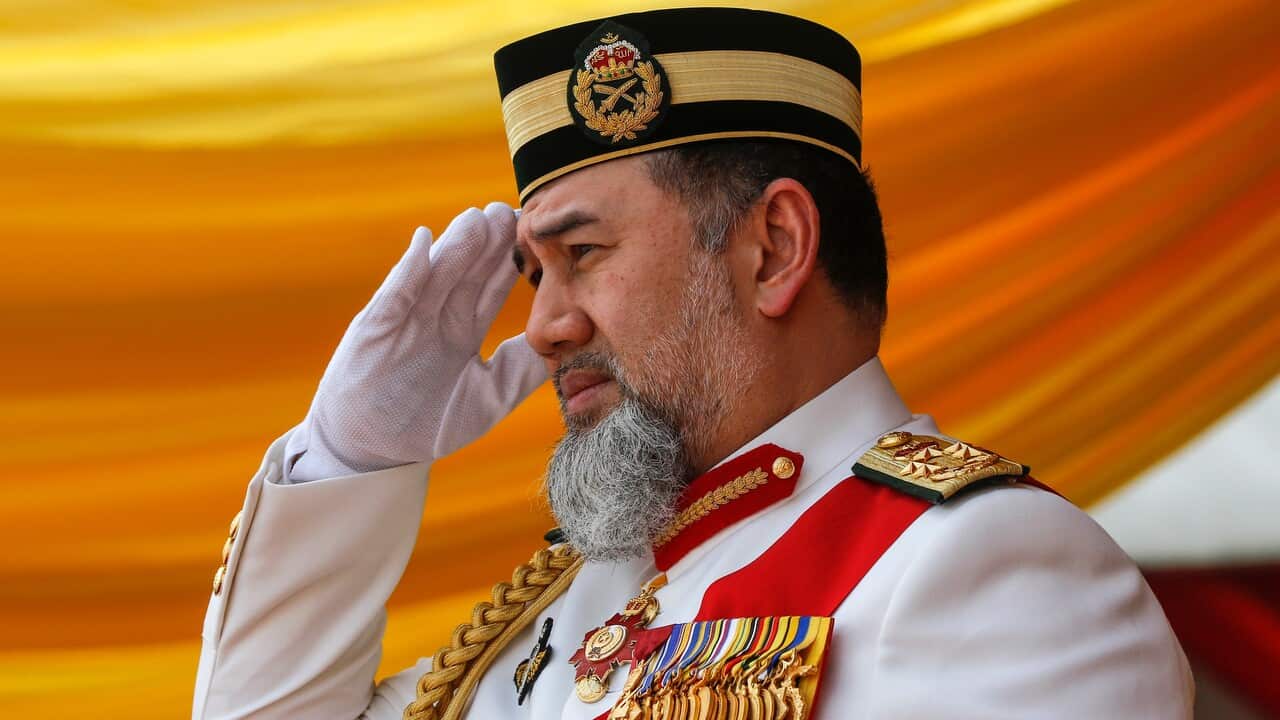 Malaysia's King Sultan Muhammad V salutes during the Trooping of Colours ceremony, on 12 September 2018.