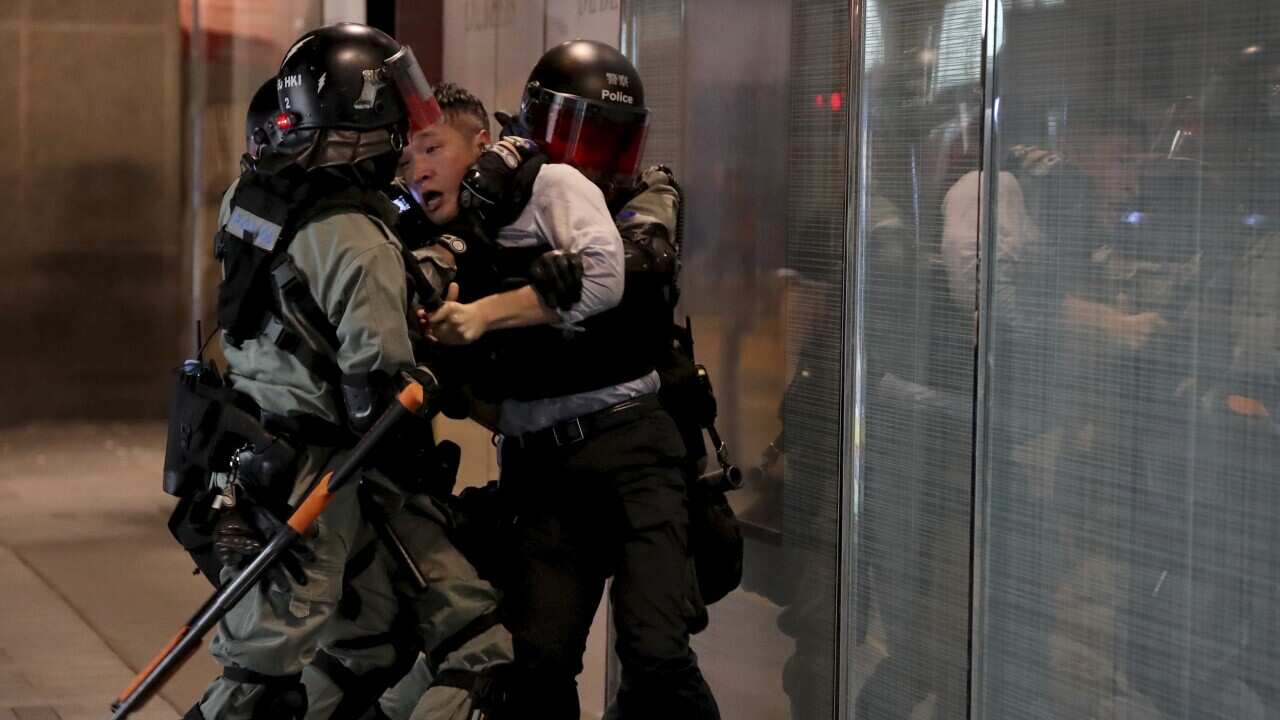 Riot police detain a man in Central in Hong Kong, Tuesday, 12 November, 2019.