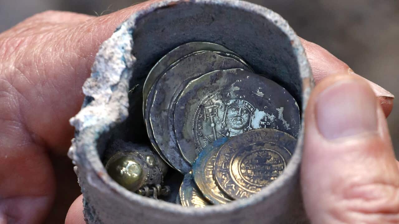 Ancient gold coins and an earring recently uncovered at an excavation site in the Israeli Mediterranean town of Caesarea.