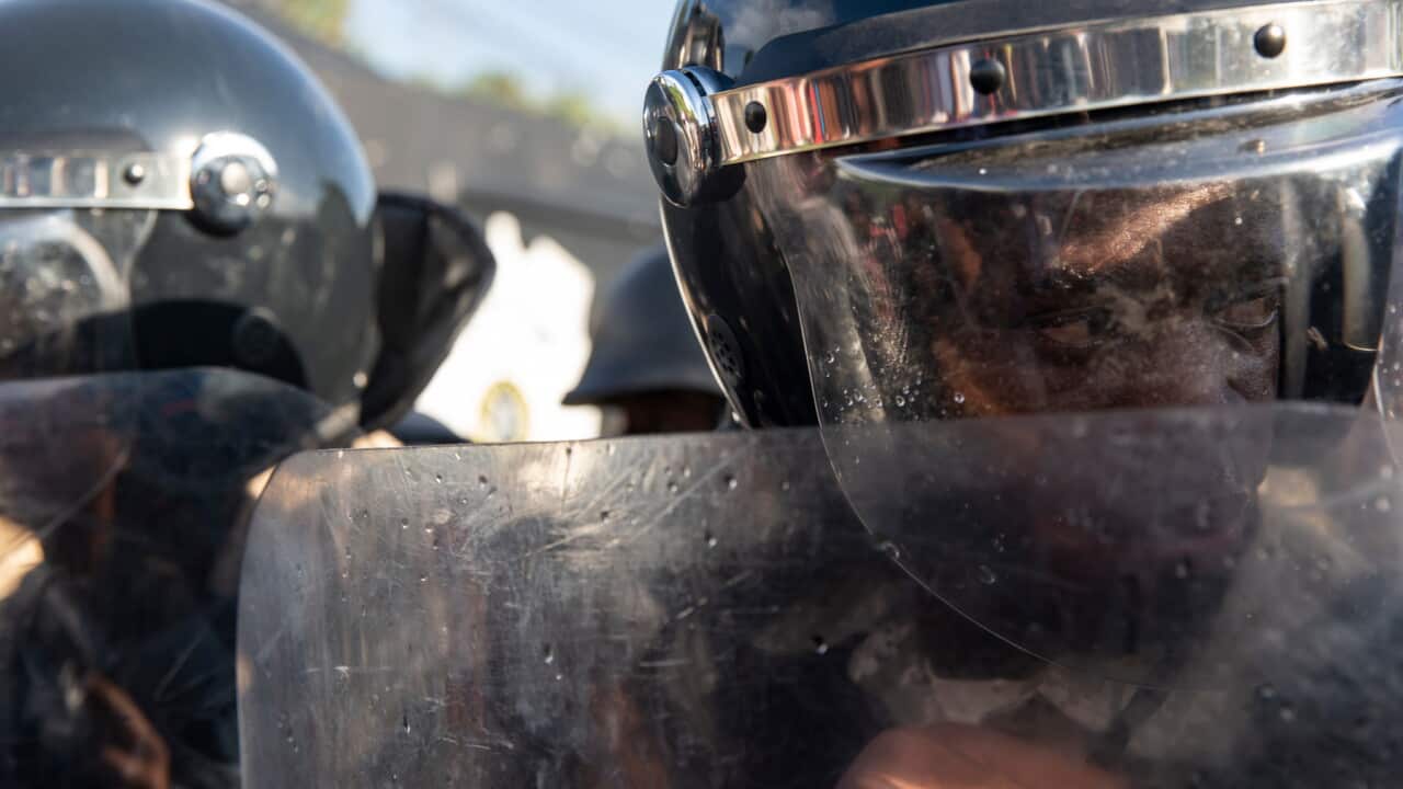 Haitian police form a barricade against protesters