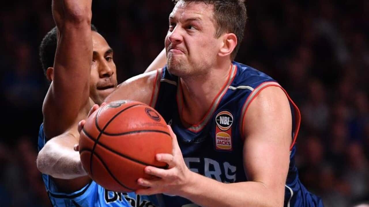 Daniel Johnson of the Adelaide 36ers (R) with the ball
