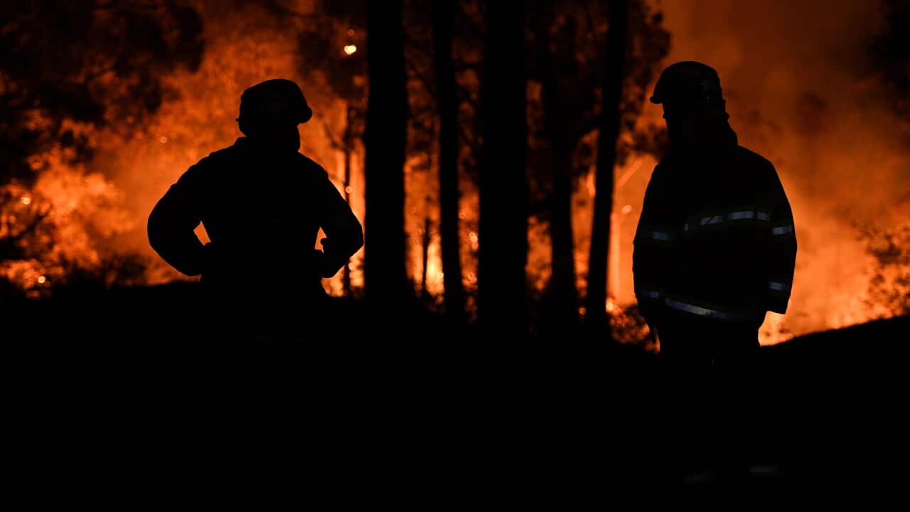 Firefighters watch on as a fire approaches a property at Colo Heights last week.