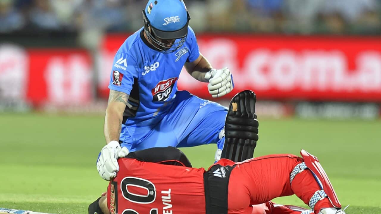 Jono Dean of the Strikers checks on Peter Nevill of the Renegades