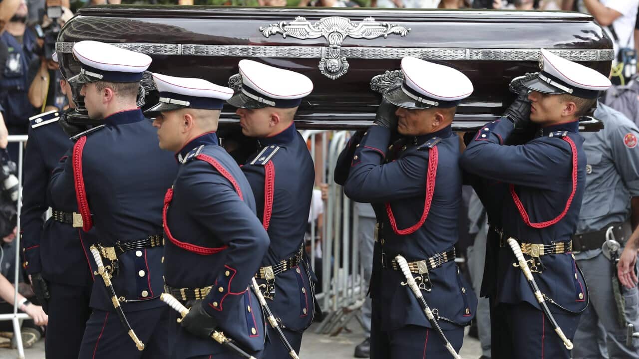 The coffin of soccer legend Pele arrives at a Santos cemetery
