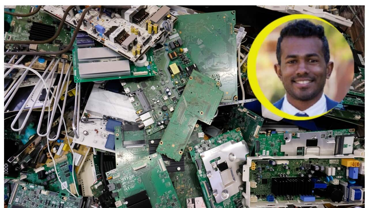 Printed circuit boards and components of electrical devices pictured in a box for electronic waste in a repair workshop.