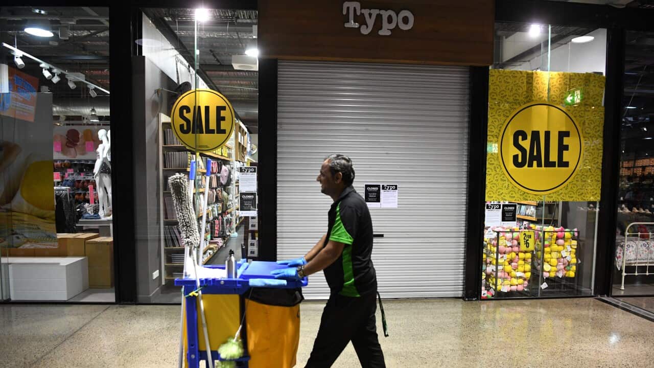 A cleaner walks through a Brisbane shopping centre