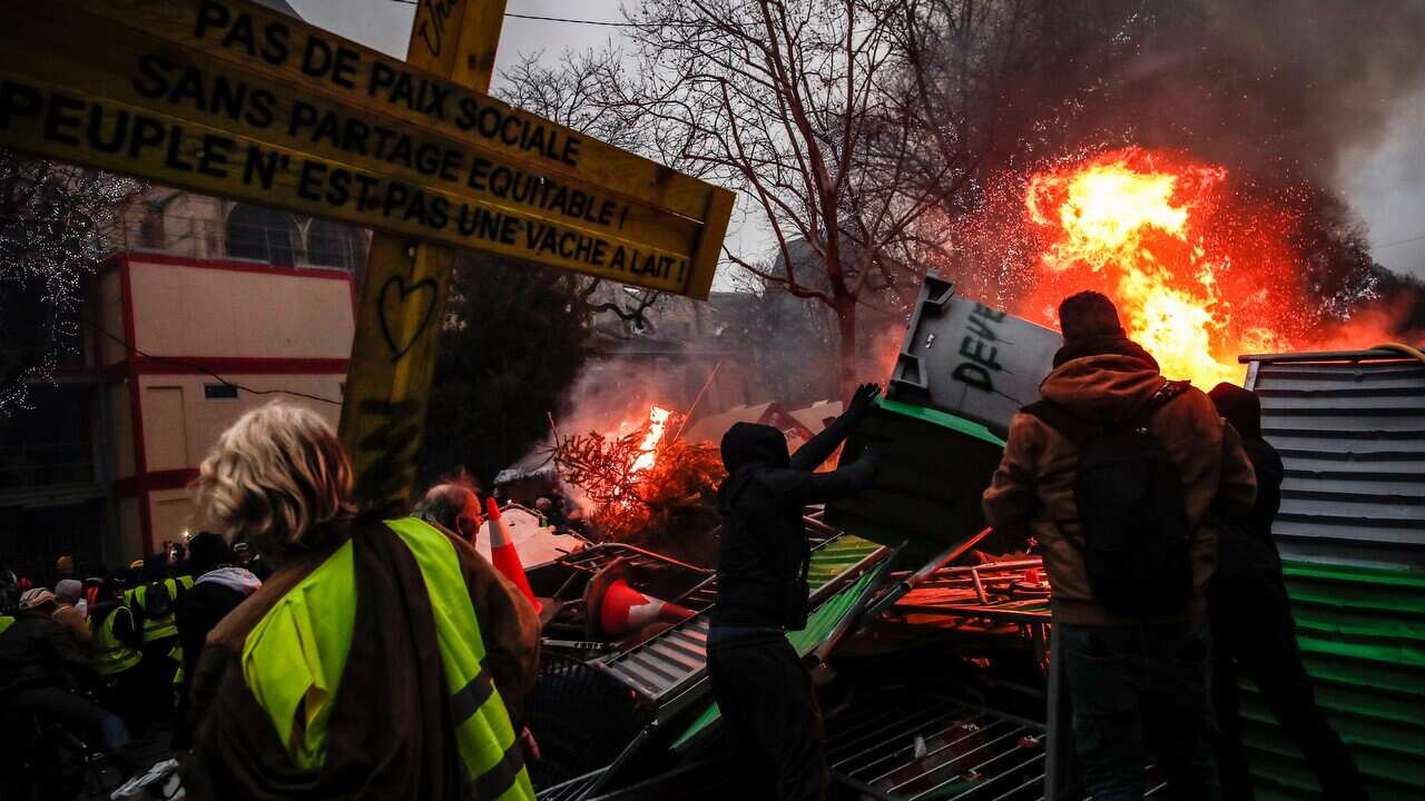 Protesters build a barricade half set on fire as clashes erupt between protesters and the French riot police during a 'yellow vests' protest in Paris.