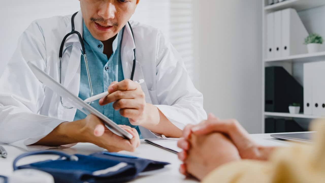 A male doctor gives test results to a patient