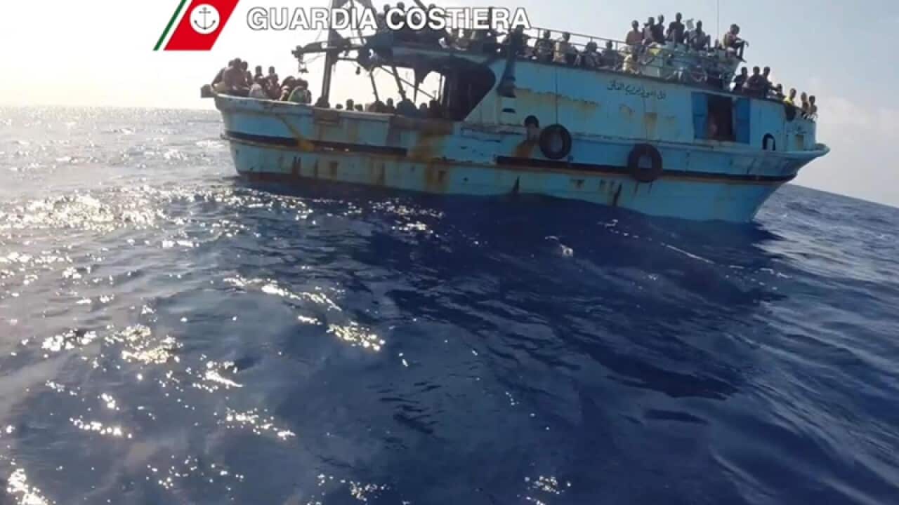 Migrants on a boat during rescue operations by Italian Navy