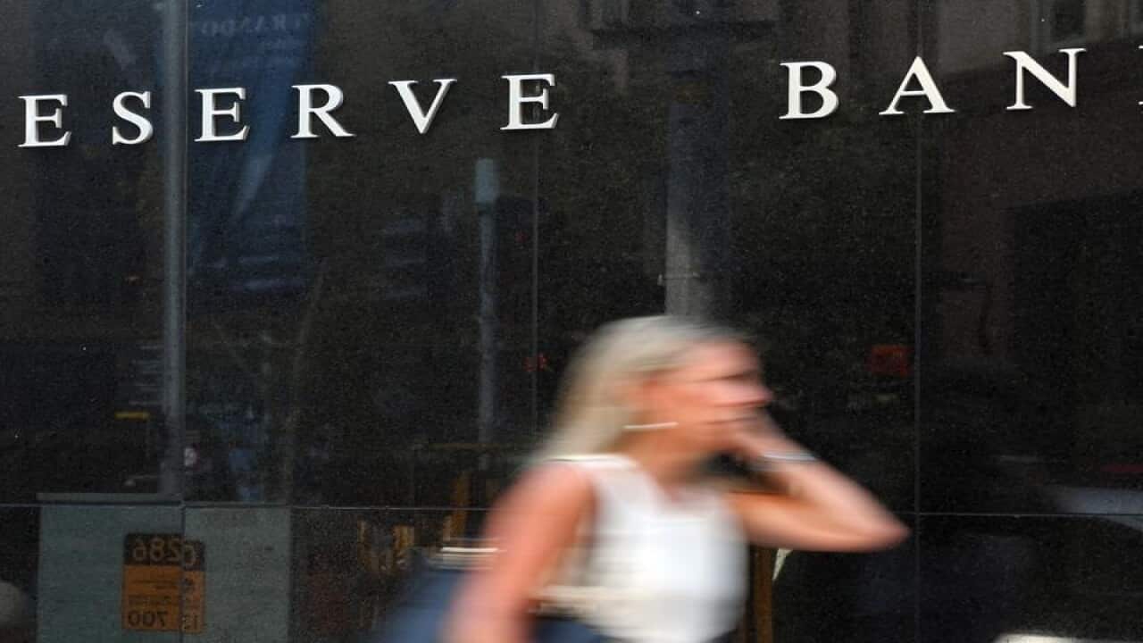 A pedestrian walks past the Reserve Bank of Australia head office.