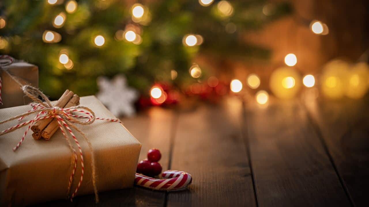 Brown Christmas gift box on rustic wooden table.