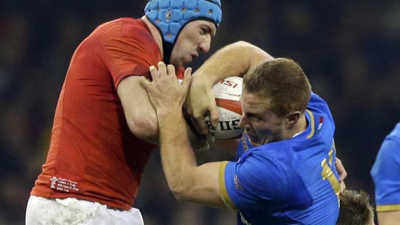 Wales' Justin Tipuric tackles Tommaso Castello of Italy.