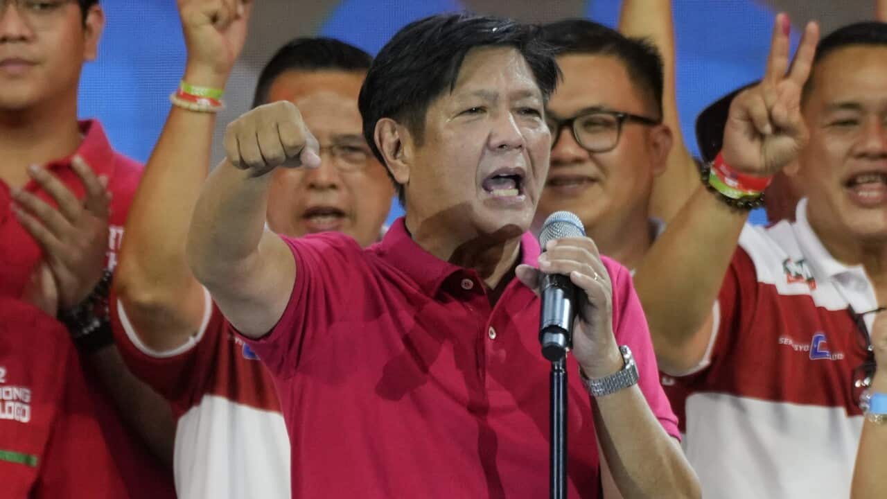 Presidential candidate Ferdinand "Bongbong" Marcos Jr., the son of the late dictator, greets the crowd during a campaign rally.