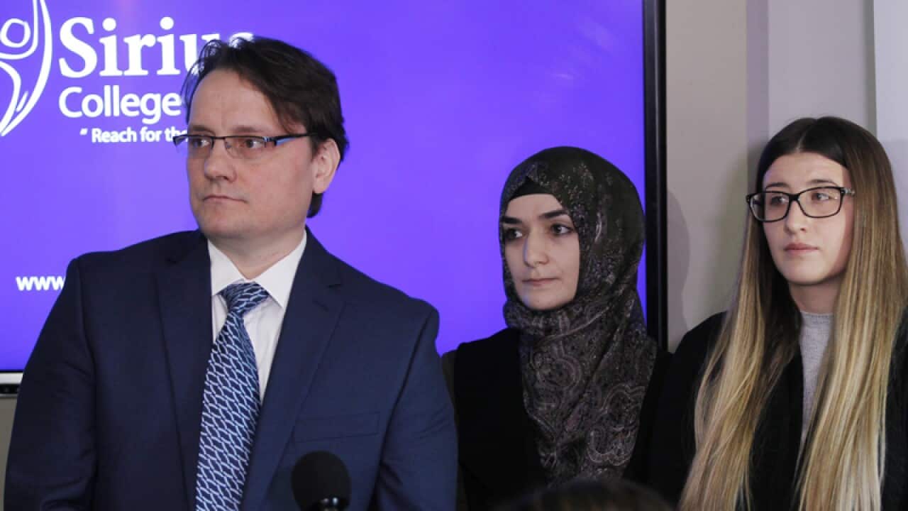 Sirius College staff at a press conference