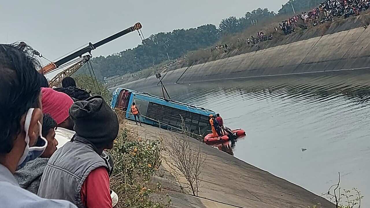 A bus that fell into a canal is pulled out in Sidhi district, in the central Indian state of Madhya Pradesh on 16 February, 2021.