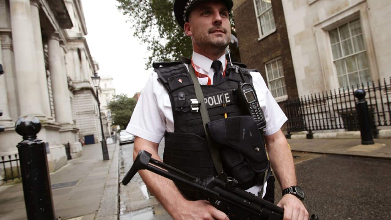 An armed police officer at Downing Street
