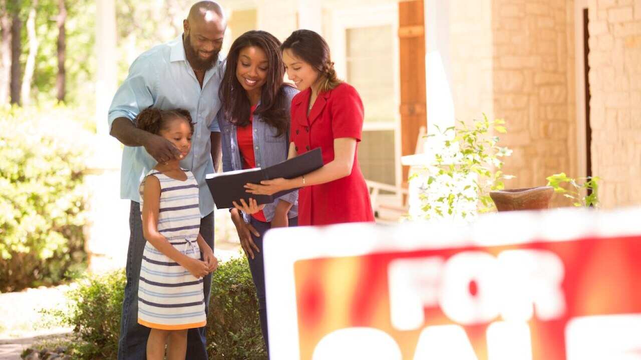 Realtor and family looking at new home to purchase.