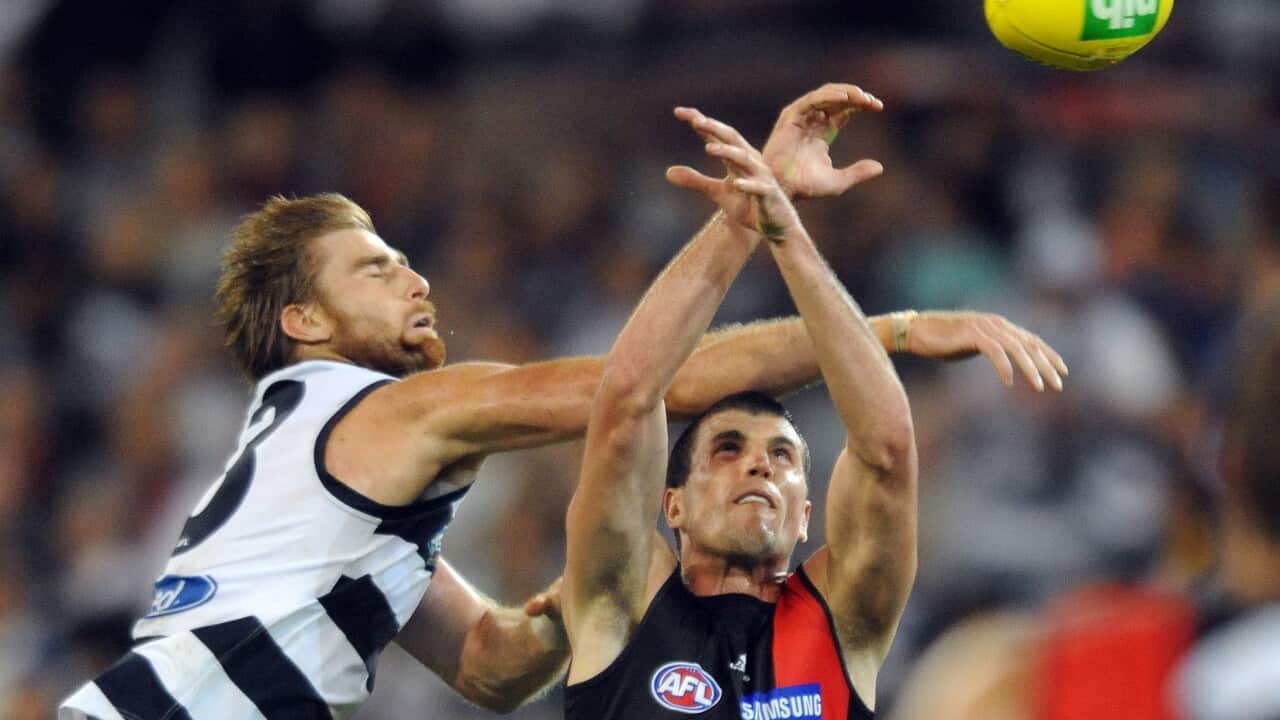 Two men playing Australian rules football