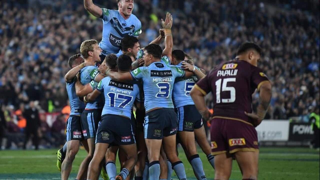 NSW Blues players celebrate winning Game 2.
