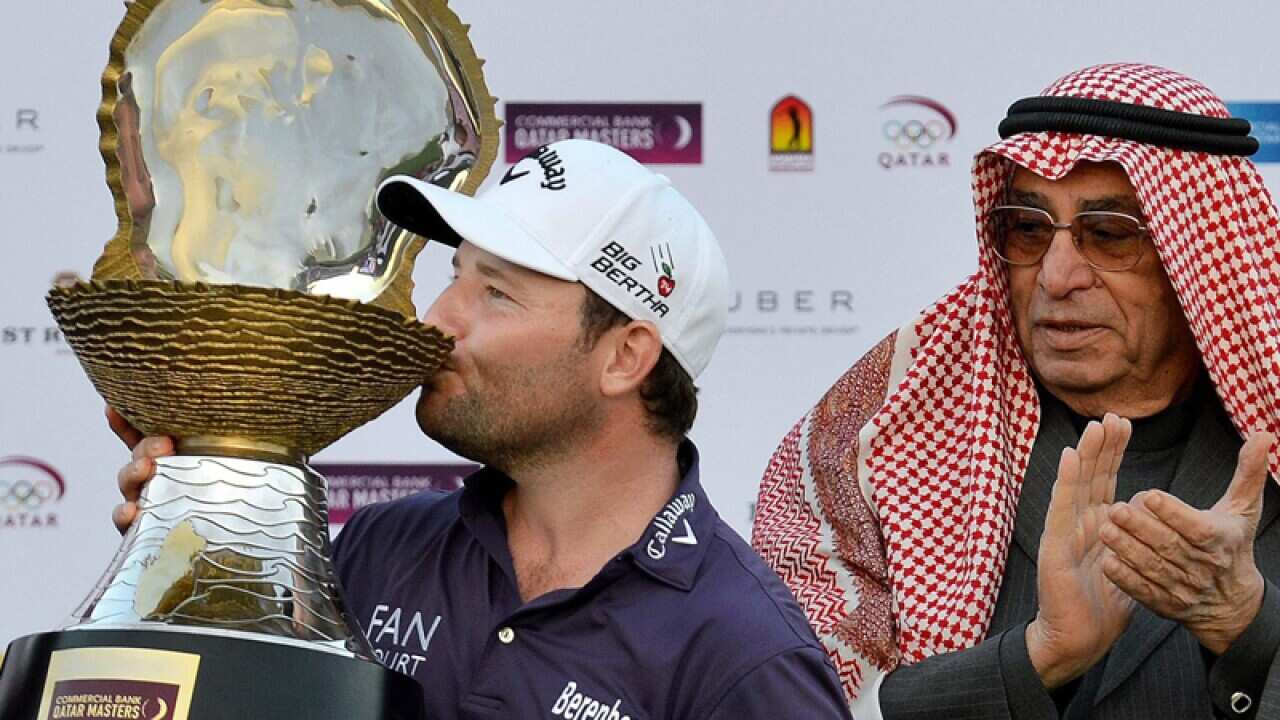 Branden Grace (L) of South Africa with the winners trophy
