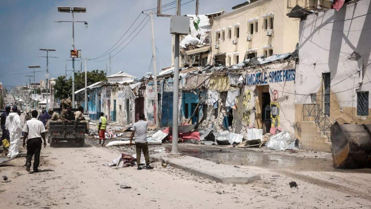 People watch outside of destroyed Hayat Hotel after a deadly 30-hour siege by Al-Shabaab jihadists in Mogadishu.