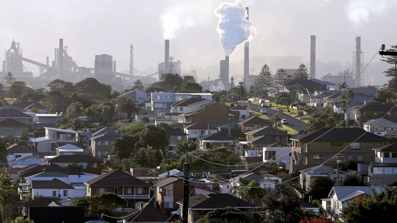 Smoke billows out of a chimney stack of steel works factories in Port Kembla, south of Sydney.