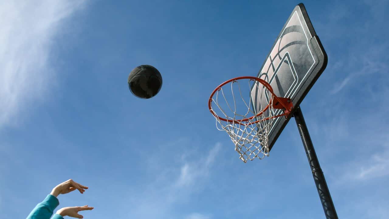 Basketball in air against blue sky