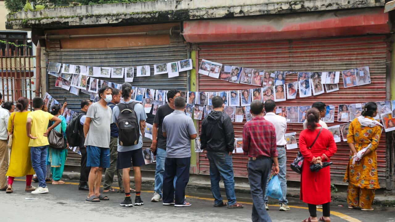 Passersby View Flood Victims Photos - Kathmandu