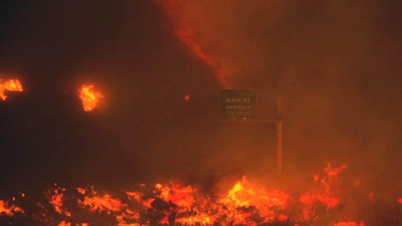 In this photo provided by Diego Topete, fire overruns the state Highway 101 near Ventura, Calif., Saturday, Dec. 26, 2015. The wind-whipped wildfire closed a major coastal highway in Southern California and forced dozens of homes to be evacuated, authorit