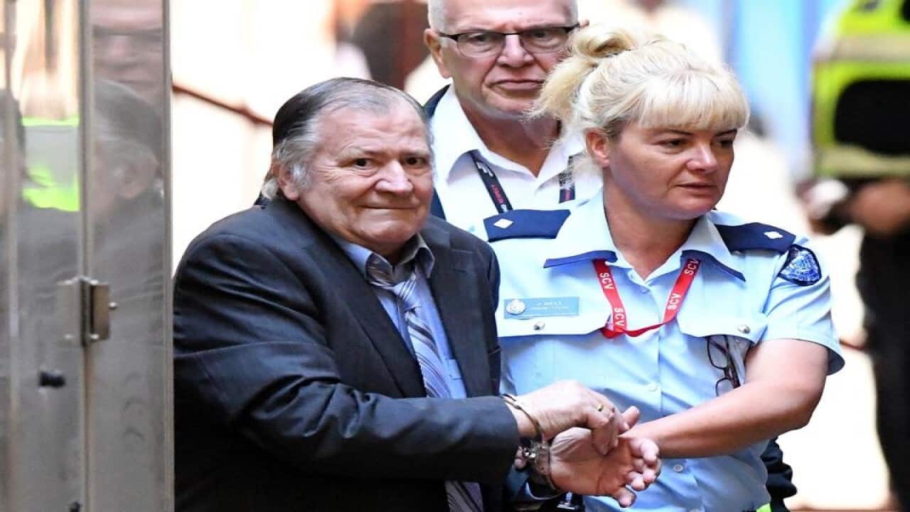 Gregory Keith Davies is escorted by into court