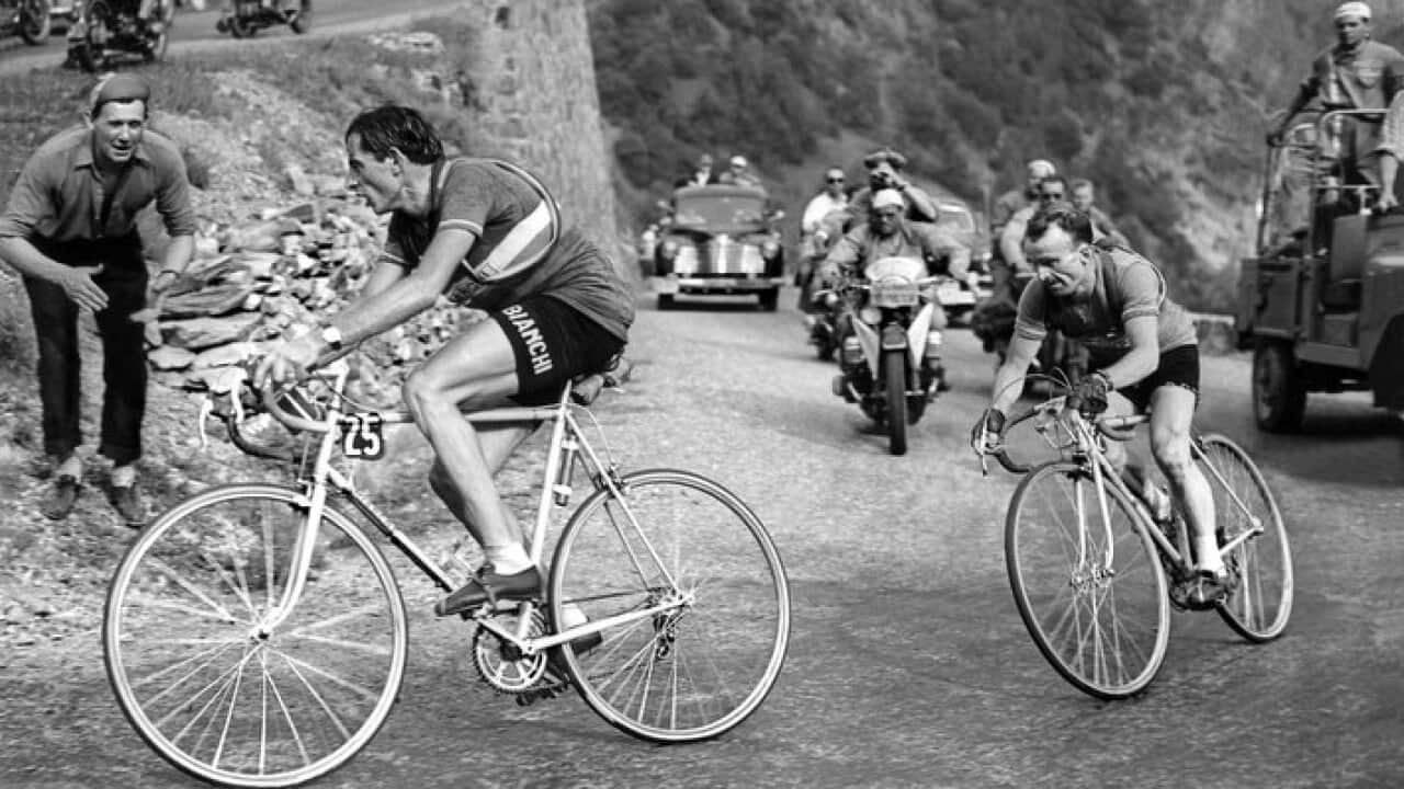 Fausto Coppi of Italy leads the pack ahead of Jean Robic of France on his way to win the 10th stage of the Tour de France cycling race from Lausanne to L'Alpe d'Huez, July 4, 1952.
