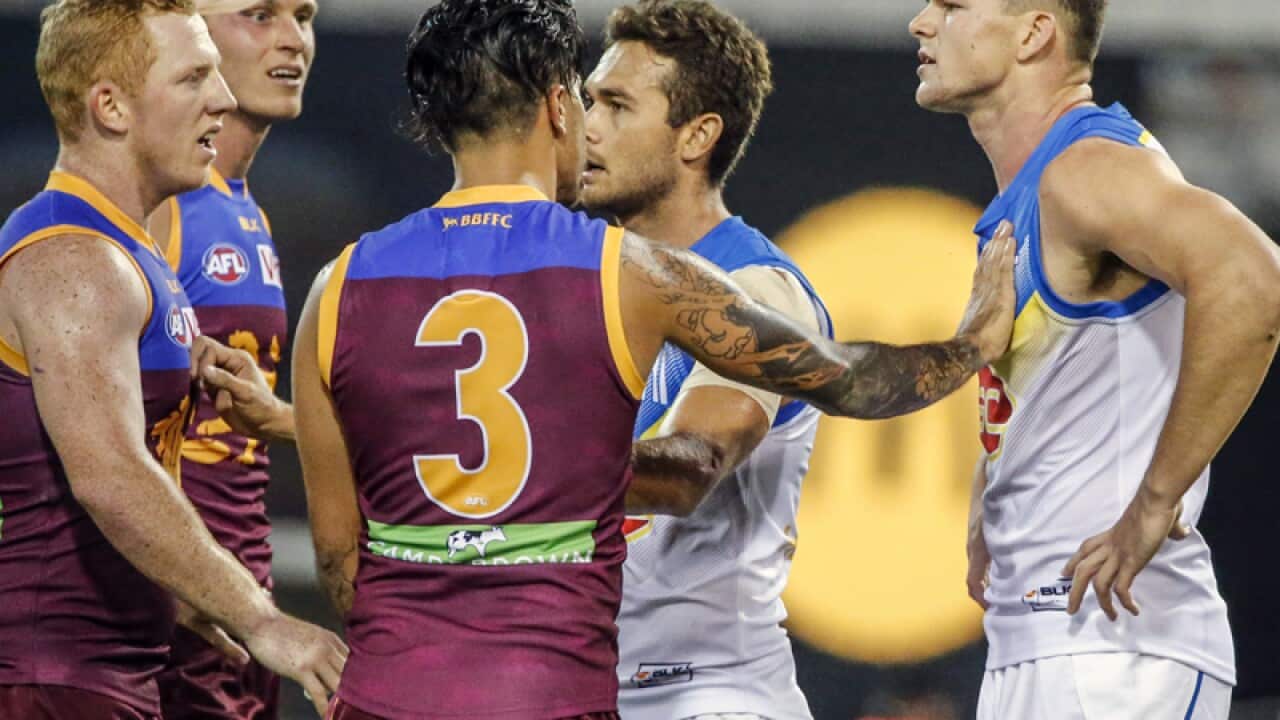 Steven May of the Suns is harrassed by Lions players