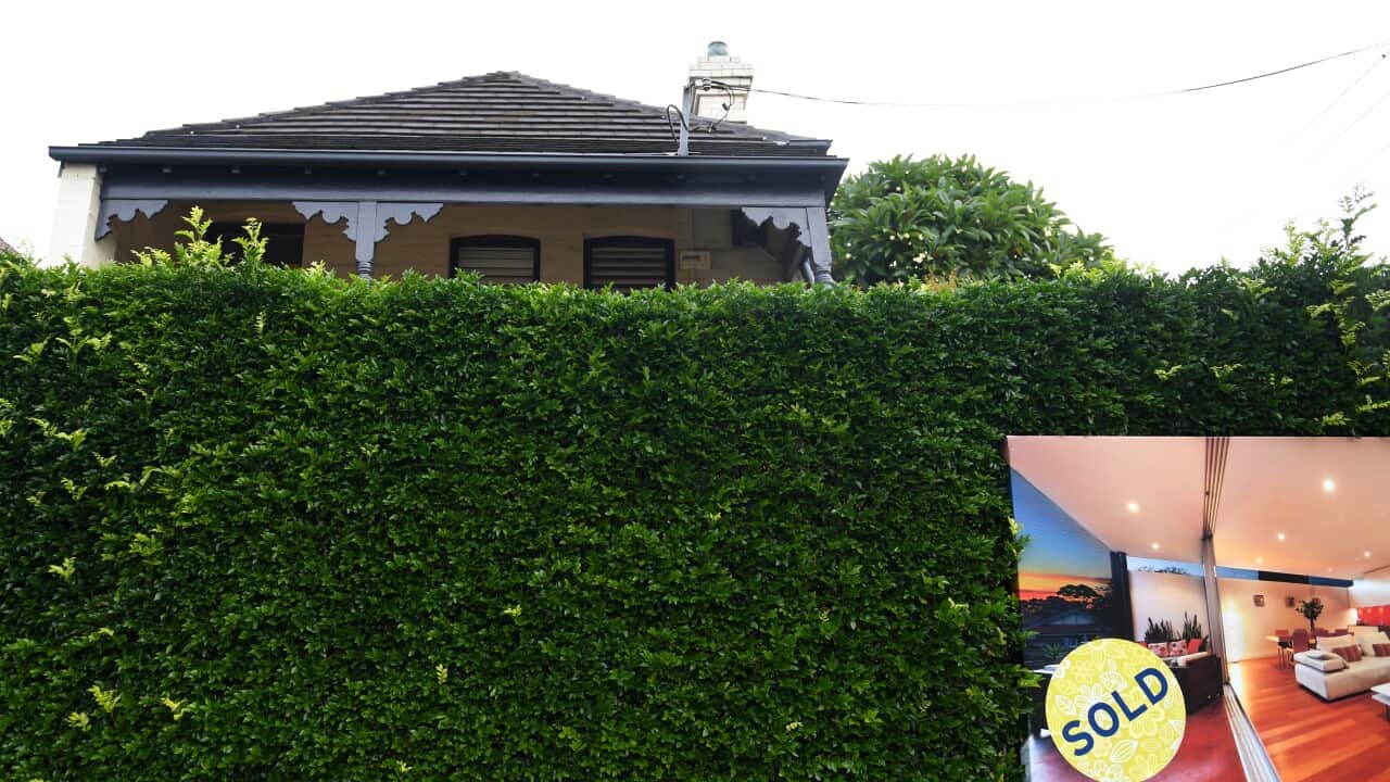 The exterior of a house with a sold sign