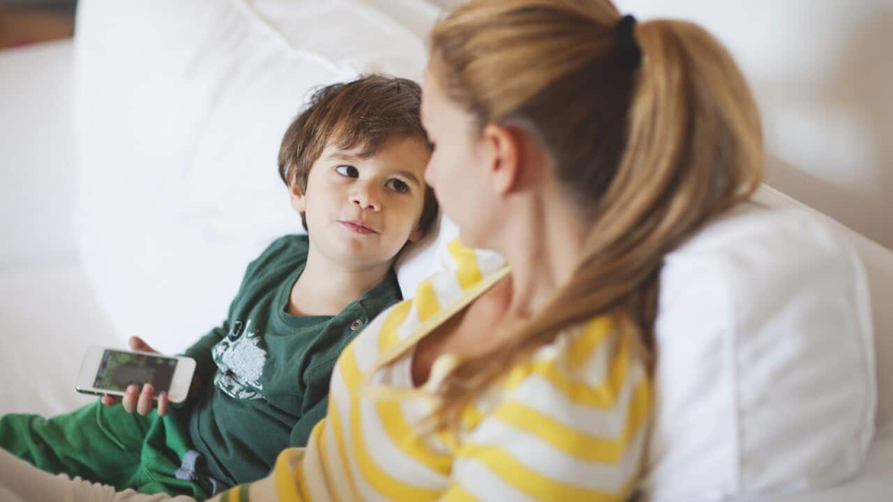 Small boy talking to his mother