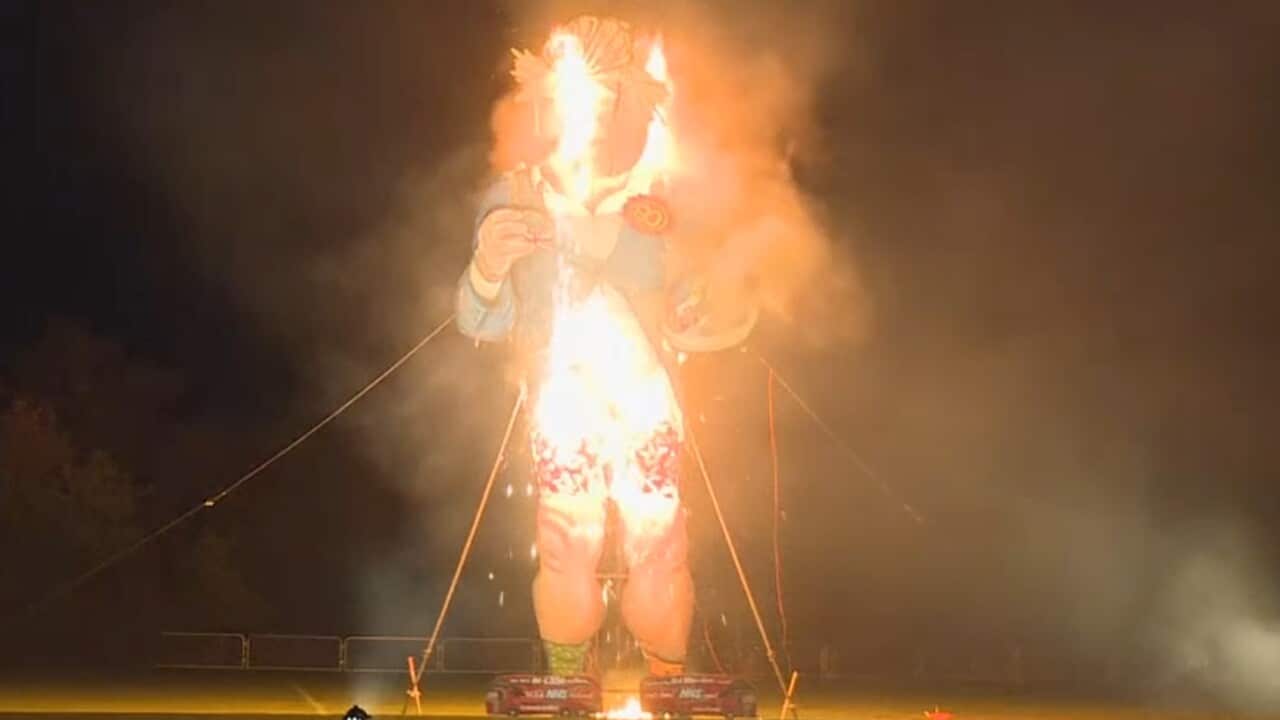 A giant effigy of Boris Johnson goes up in flames. 
